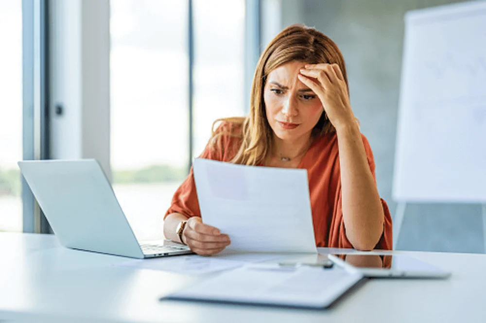 Woman looking at bills